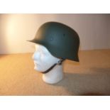 A GERMAN HELMET AND LINER LATE 20TH CENTURY