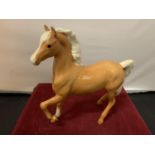 A BESWICK PALOMINO PONY WITH A BOX