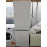 A WHITE BEKO UPRIGHT FRIDGE FREEZER BELIEVED IN WORKING ORDER BUT NO WARRANTY