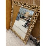 A DECORATIVE GILT EDGE FRAMED WALL MIRROR (H:124CM W:102CM)