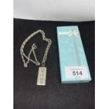 A SILVER INGOT AND CHAIN IN A PRESENTATION BOX