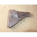 A BROWN LEATHER PISTOL HOLSTER