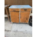 A VINTAGE WOODEN KITCHEN UNIT ENCLOSING TWO DRAWERS AND TWO DOORS
