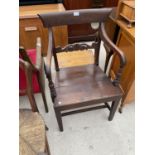 A 19TH CENTURY OAK ELBOW CHAIR WITH SOLID SEAT