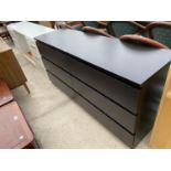 A MODERN BLACK ASH EFFECT CHEST OF SIX DRAWERS, 63" WIDE