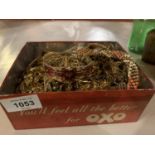 A VINTAGE OXO TIN AND ITS CONTENTS OF YELLOW METAL COSTUME JEWELLERY
