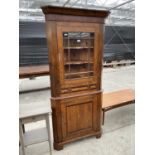 A GEORGE III STYLE OAK AND MAHOGANY CROSSBANDED CORNER CABINET ON BRACKET FEET WITH GLAZED UPPER