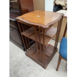 AN EDWARDIAN OAK REVOLVING BOOKCASE (LACKING BASE)