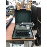 A CASED VINTAGE OLYMPIA TYPE WRITER
