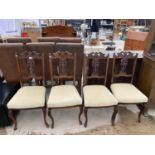 FOUR CARVED MAHOGANY DINING CHAIRS