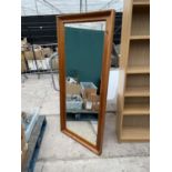 A MODERN PINE FRAMED MIRROR 69 INCHES X 25 INCHES