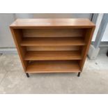 A RETRO "GIBBS FURNITURE" OPEN TEAK BOOKCASE, 36" WIDE, ON BLACK METAL LEGS