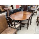 A MAHOGANY EXTENDING DINING TABLE ON TWIN PEDESTAL SUPPORTS WITH SIX SHIELD BACK DINING CHAIRS