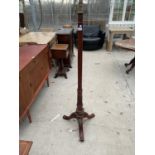 A REPRODUCTION CARVED MAHOGANY STANDARD LAMP ON TRIPOD BASE