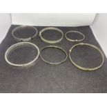 SIX SILVER BANGLES