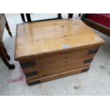 A SMALL PINE TWO HANDLED TRUNK WITH METAL STRAPS, 20.5x14"