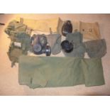 A GAS MASK, GROUNDSHEET, CANTEEN DATED 1974, COVER ETC