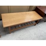 A RETRO TEAK COFFEE TABLE, 42x16" WITH TURNED UNDERSHELF