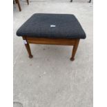 A RETRO LOW TEAK STOOL WITH UPHOLSTERED ADJUSTABLE TOP, ON TAPERED LEGS