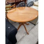 A CIRCULAR BEECH DINING TABLE