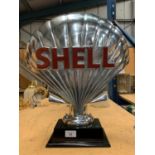 A LARGE CHROME SHELL LOGO SIGN ON A PLINTH HEIGHT APPROXIMATELY 50CM