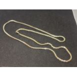 A SILVER NECKLACE APPROXIMATELY 26 INCHES LONG