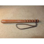 A WOOD POLICEMANS TRUNCHEON, LENGTH 40CM, WITH LEATHER WRIST ATTACHMENT