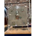 AN ORNATE VINTAGE FIRESCREEN DEPICTING VARIOUS ANIMALS