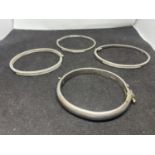 FOUR BANGLES THREE MARKED SILVER AND ONE POSSIBLY SILVER