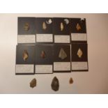 ELEVEN PALEOLITHIC FLINT ARROWHEADS (CIRCA 40,000 B.C.), EIGHT MOUNTED ON CARD WITH EXPLANITORY