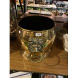 A VERY LARGE BRASS COAL/LOG RECEPTACLE WITH ORNATE LION HEAD HANDLES (WIDTH 44CM X HEIGHT 27CM)