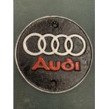 A METAL AUDI BADGE PLAQUE