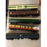 FIVE OO GAUGE PASSENGER CARRIAGES TO INCLUDE AN AMBULANCE AND A HOGWARTS RAILWAYS ETC