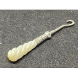 A SILVER HOOK WITH MOTHER OF PEARL HANDLE