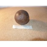 A CAST IRON CANNONBALL RECOVERED FROM THE WRECK OF H.M.S. ASSOCIATION. THE SHIP SANK IN 1707 WITH