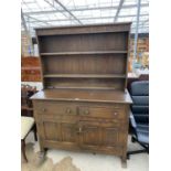 A REPRODUCTION OAK DRESSER, 49" WIDE, WITH FOLIATE DECORATION TO RACK AND FRIEZE