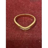 A 9 CARAT GOLD WISHBONE STYLE RING WITH SEVEN DIAMONDS