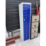 A TALL METAL CABINET WITH 15 LOCKER DOORS