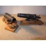 A PAIR OF MODEL CARRONADES, 21CM LONG, CAST IRON BARRELS MOUNTED ON A SLIDING OAK FRAME, LENGTH