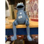 A WOODEN COOKIE MONSTER FIGURE TO SIT ON A SHELF