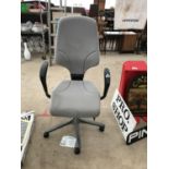 A PADDED GREY OFFICE SWIVEL CHAIR