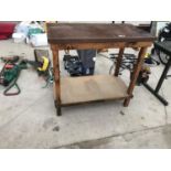 A WOODEN WORK BENCH WITH SHELF UNDERNEATH