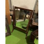 A WOODEN FRAMED PIVOT DRESSING TABLE/TOILET MIRROR WITH FINIALS