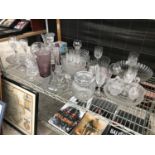 A LARGE ASSORTMENT OF GLASS WARE TO INCLUDE CUT GLASS BOWLS AND VASES ETC