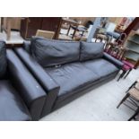 A LARGE LEATHER TWO SEATER SOFA