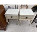 A PAIR OF GILDED CREAM BEDSIDE CABINETS