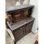 A SMALL PRIORY OAK COURT CUPBOARD WITH TWO LOWER DOORS AND DRAWERS AND AN UPPER DOOR