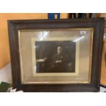 A FRAMED BLACK AND WHITE PHOTOGRAPHIC PORTRAIT OF A GENTLEMAN AT HOME