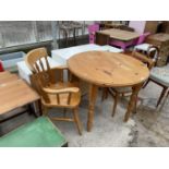 A MODERN CIRCULAR PINE DINING TABLE 36" DIAMETER, ELBOW CHAIR AND A KITCHEN CHAIR