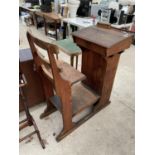 A VICTORIAN PITCH PINE ALL IN ONE SCHOOL DESK AND CHAIR WITH ORIGINALPOT INK WELL